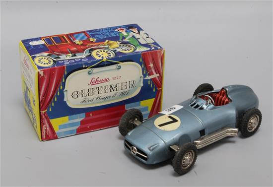A Schuco 1227 Old Timer Ford Coupe model, boxed and a Western Germany tinplate model of a Mercedes racing car